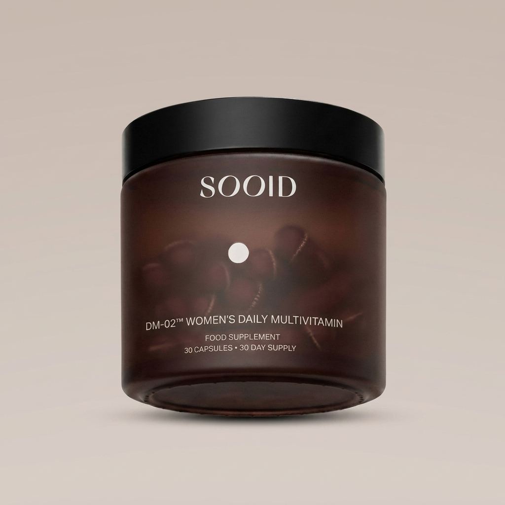 SOOID DM-02 Women's Daily Multivitamin amber glass jar with matte black lid on a warm beige background