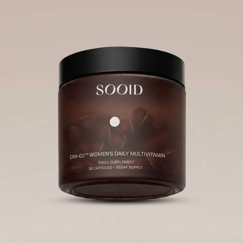 SOOID DM-02 Women's Daily Multivitamin amber glass jar with matte black lid on a warm beige background