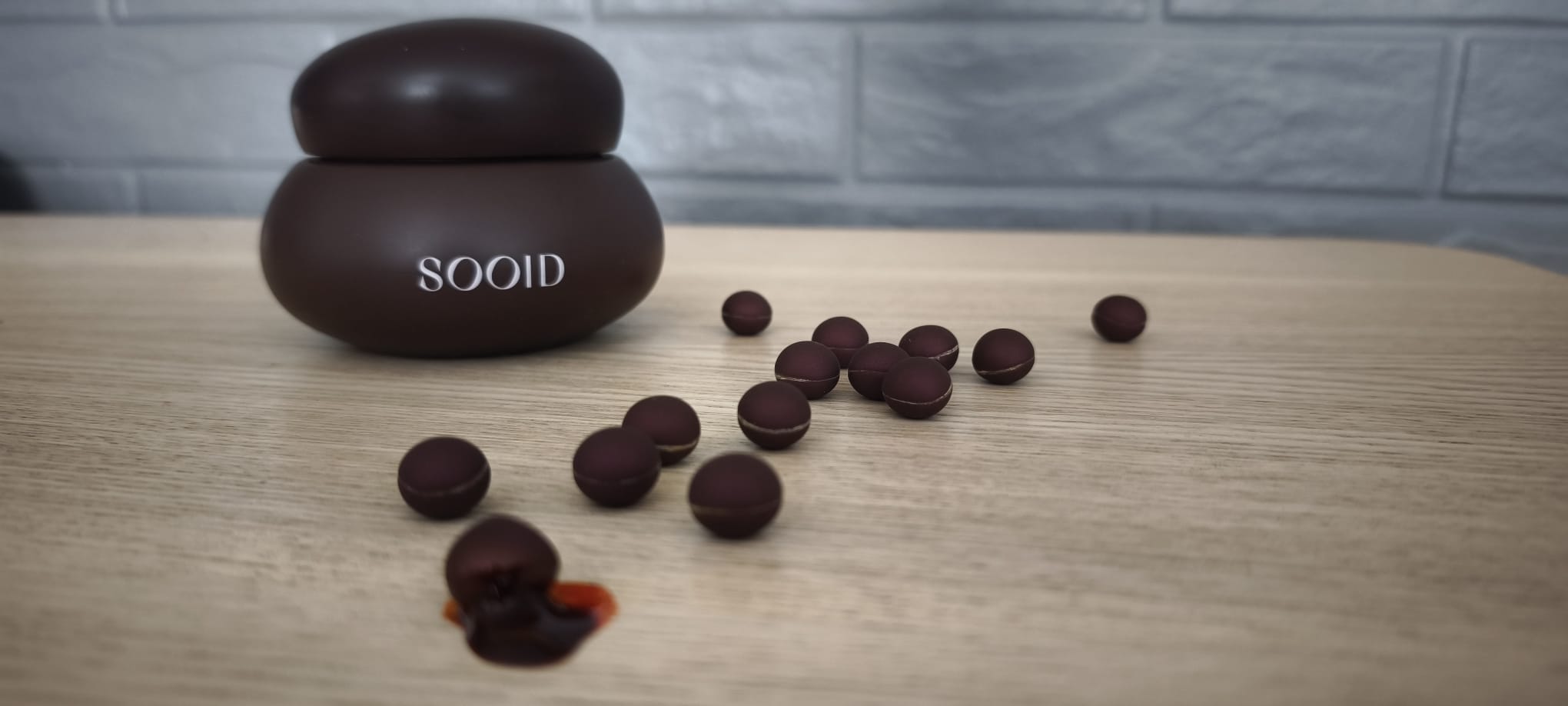 SOOID chocolate capsule bitten open, carotenoid oil inside.